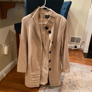 Tan wool coat with black buttons.